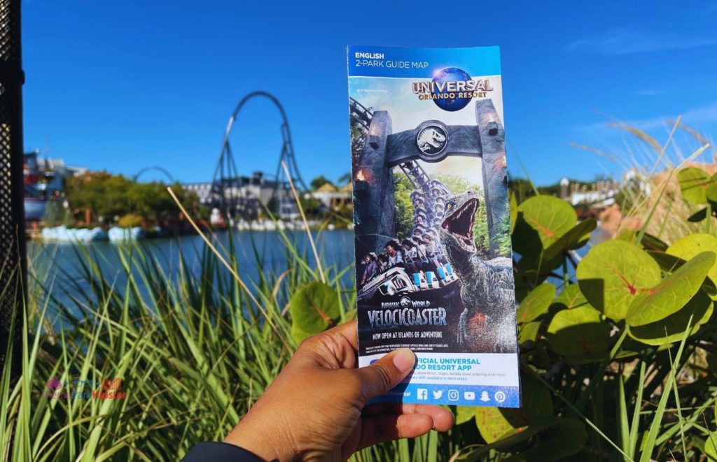 Universal Orlando Resort Lagoon with park map overlooking velocicoaster at Islands of Adventure. Keep reading to learn how to have the best Universal Orlando Solo Trip for Travelers going to theme parks alone.