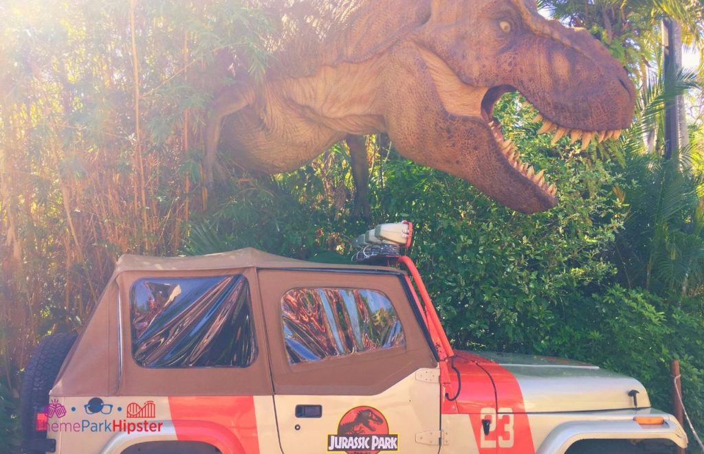 Universal Orlando Resort Tyrannosaurus Rex in front of Jurassic Park Jeep at Islands of Adventure. Keep reading to get the best movies to watch before going to Universal Studios and Islands of Adventure.