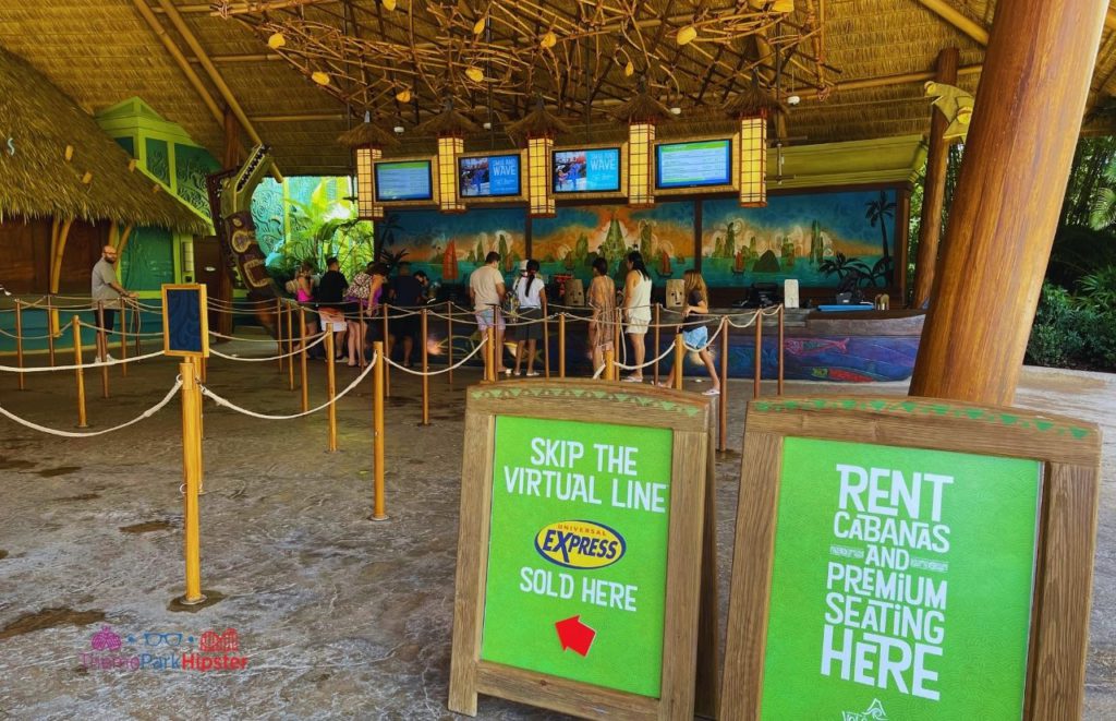Green signs advertising the Express Passes and Cabana Rentals at Universal Orlando Resort Volcano Bay. Keep reading to to find out more Mistakes to Avoid at Universal Orlando Resort! 