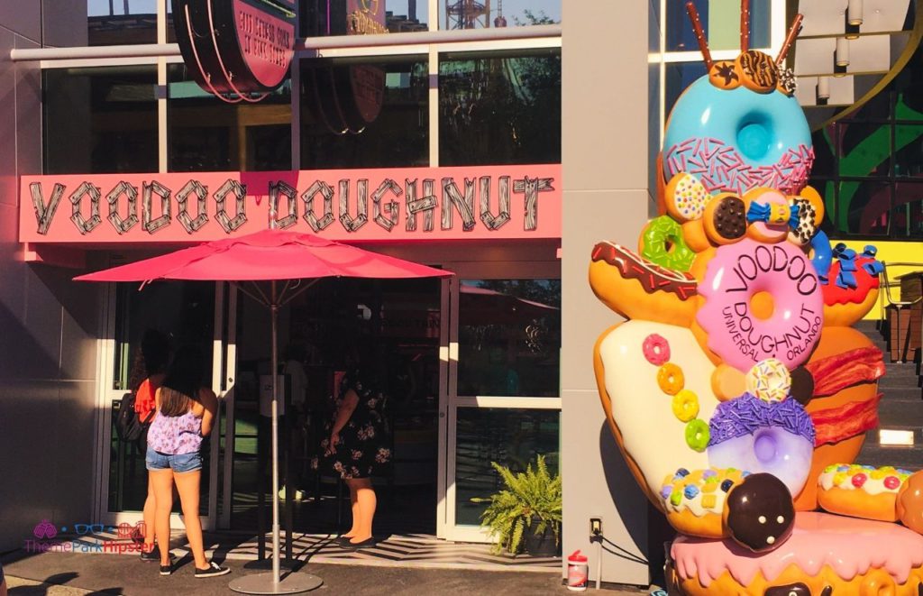 Large chair made of fake oversized doughnuts in from of the Voodoo Doughnut entrance at Universal Orlando Citywalk . Keep reading to find out what are the best Universal Orlando Snacks under $10.