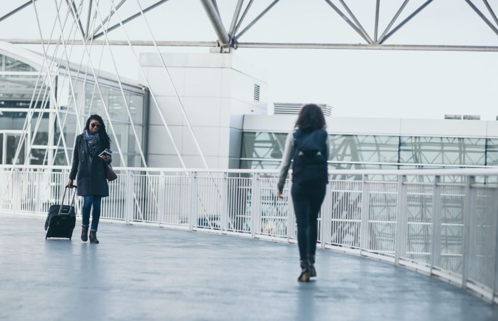 Black Lady Solo Traveler in the Airport. Keep reading to learn how to deal with traveling alone with anxiety on your solo trip