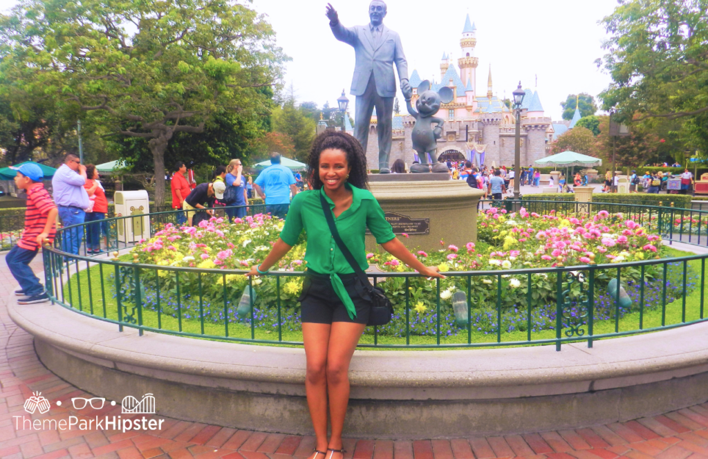 Disneyland Outfit ideas with NikkyJ and Walt and Mickey Mouse Statue. Keep reading to learn what to wear to Disneyland in July.