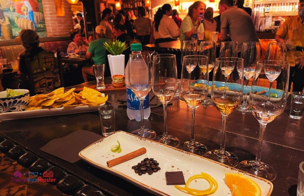Epcot La Cava del Tequila Mexico Pavilion sampling of drinks, cleansing items like cinnamon, chocolate and orange and guacamole and chips. Keep reading to find out more about tequila tasting Epcot.