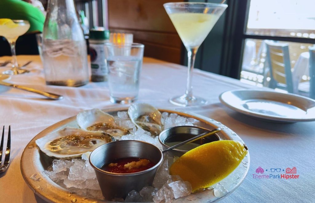 The BOATHOUSE Orlando Lemon drop martini cocktail with oysters. Keep reading to get the best drinks at Disney Springs and the best adult beverages at Walt Disney World!