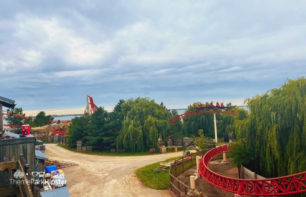 Red tracks of the Maverick Roller Coaster snakes across the Cedar Point landscape and over the aged wodden fence and drink roads of FrontierTown. Keep reading if you want to learn more about the history, theme, ride stats and fun facts about the Maverick at Cedar Point!