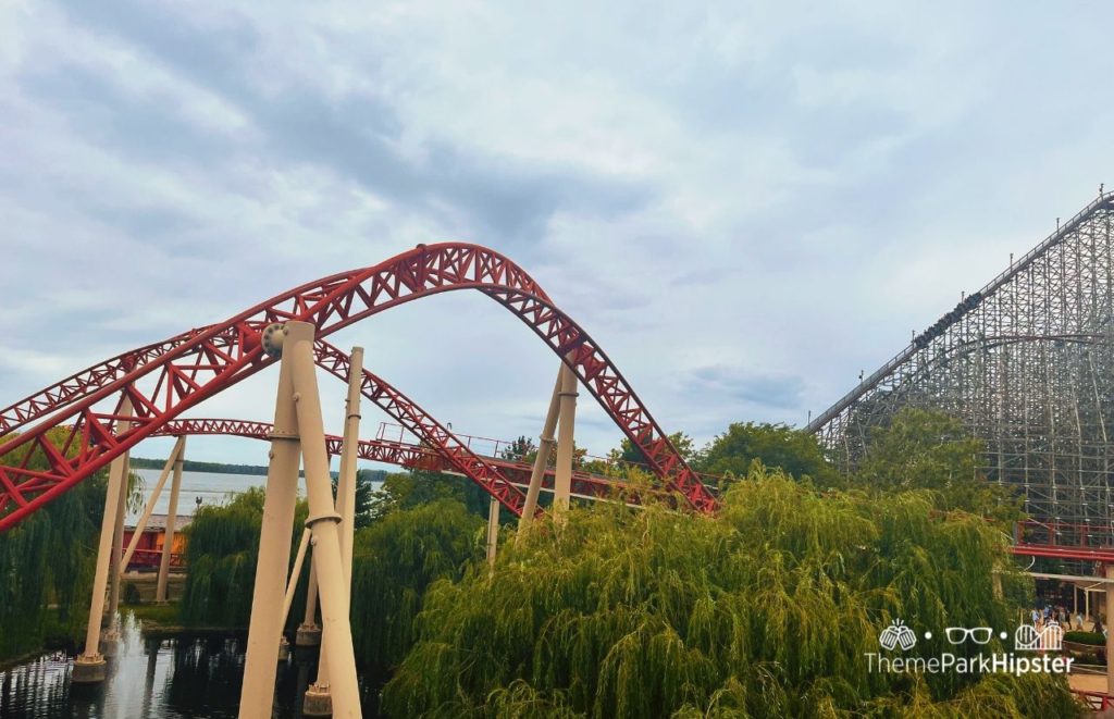 Red tracks and yellow support beams tower above the trees at Cedar Point, as Steel Vengeance lurks high in the distance. Keep reading if you want to learn more about the history, theme, ride stats and fun facts about the Maverick at Cedar Point!