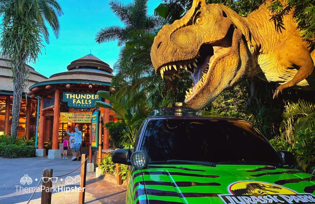 Jurassic Park River Adventure with Tyrannosaurs above green jeep next to Thunder FallsUniversal Orlando Resort Islands of Adventure. Keep reading to get the best movies to watch before going to Universal Studios and Islands of Adventure.