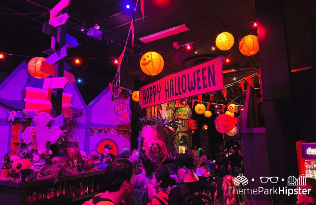 Happy Halloween sign with hanging Pumpkin Japanese Lanterns and string light in a Halloween Horror Nights 2022 display at Universal Orlando Resort. Keep reading to to find out more Mistakes to Avoid at Universal Orlando Resort!