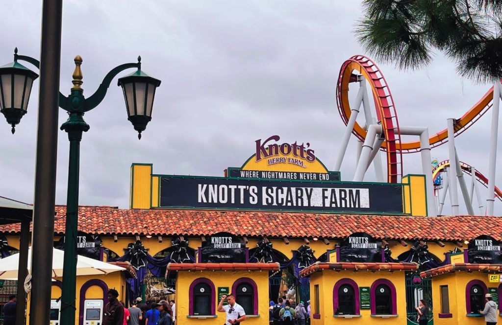 Silver Buller Red Orange Roller Coaster at the Entrances to Knott's Berry Farm at Halloween 2023 Knott's Scary Farm. Keep reading to learn about Knott's Berry Farm Halloween.