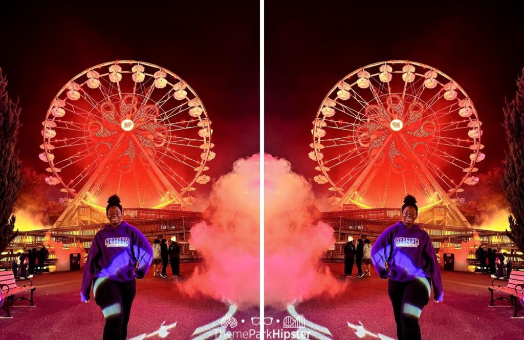 Victoria Wade in front of Ferris Wheel during Halloween at Hersheypark Dark Nights. Keep reading to learn about Halloween at Hersheypark in Hershey, Pennsylvania!