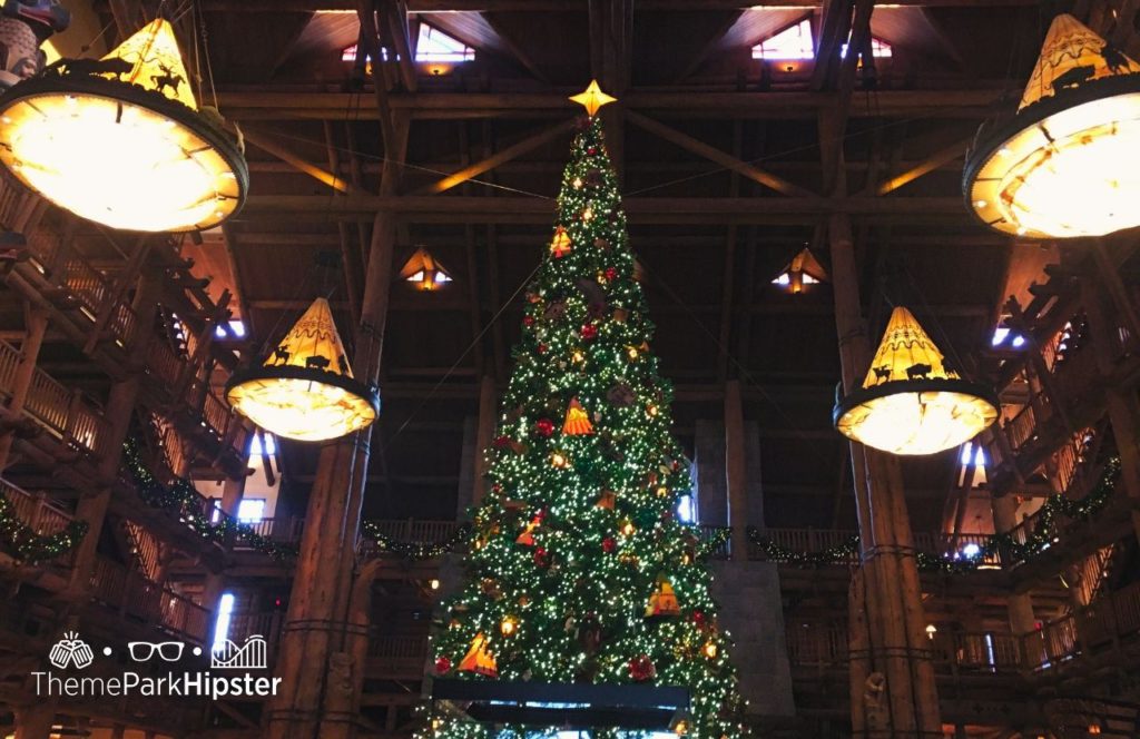 Disney Wilderness Lodge at Christmas with Large Christmas Tree. One of the best things to Do at Disney World for Christmas. Keep reading to learn about the best Disney Christmas trees!