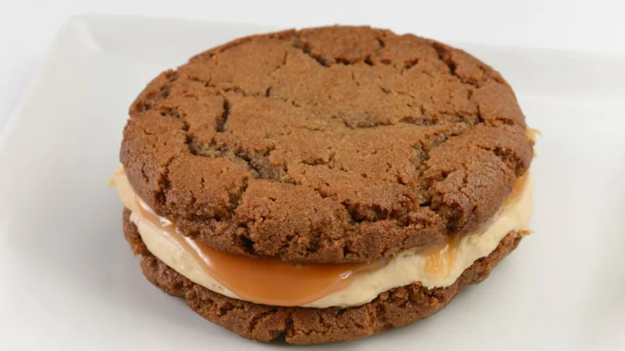 Werther’s Original Caramel Gingerbread Cookie Sandwich- Two soft Gingerbread Cookies with Buttercream Icing and Werther’s Original Caramel at Epcot Festival of Holidays. Keep reading to get the best Disney Christmas treats and desserts on this foodie guide.