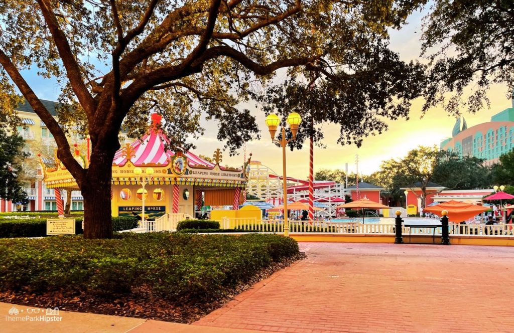 Christmas at Disney Boardwalk Inn and Villas Leaping Horse Libations bar at pool with Swan Resort in background. Keep reading to find out the most romantic resorts for couples at Walt Disney World.  