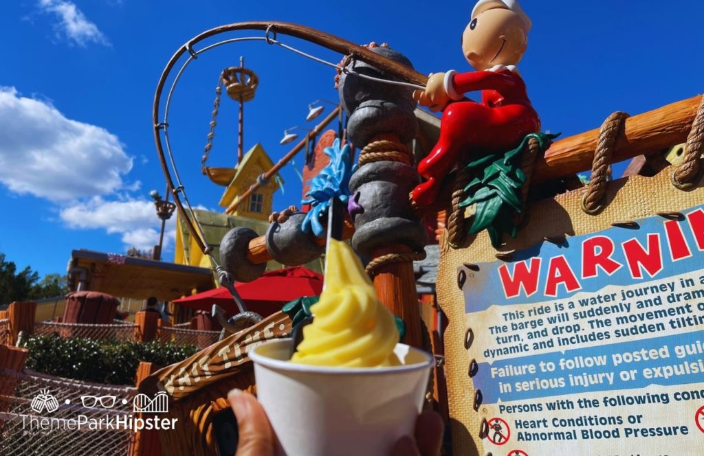 Universal Orlando Resort eating Dole Whip at Wimpy's in Islands of Adventure Toon Lagoon in front of Popeye Ride. Keep reading to get the best Universal's Islands of Adventure photos!