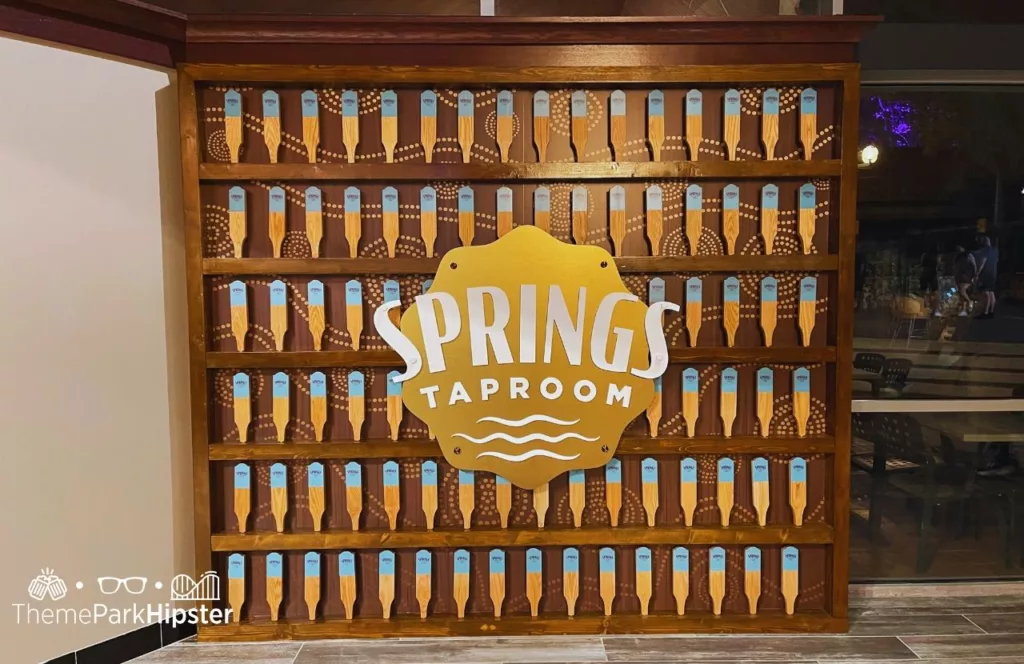 Springs Taproom signage of gold white brown and blue during Busch Gardens Tampa Food and Wine Festival. Keep reading to learn more about Busch Gardens Tampa restaurants.