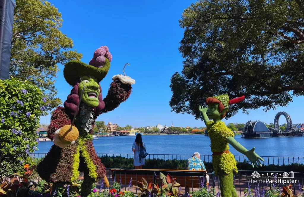 Epcot Flower and Garden Festival 2023 Captain Hook and Peter Pan Topiary in the UK Pavilion. Keep reading to see the best epcot flower and garden topiaries through the years!