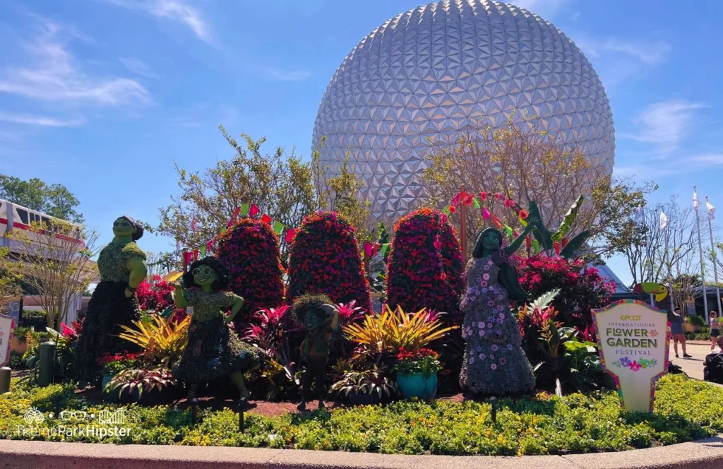 Epcot Flower and Garden Festival  Merchandise Guide for 2023 with Encanto Topiary at the Entrance near Spaceship Earth.