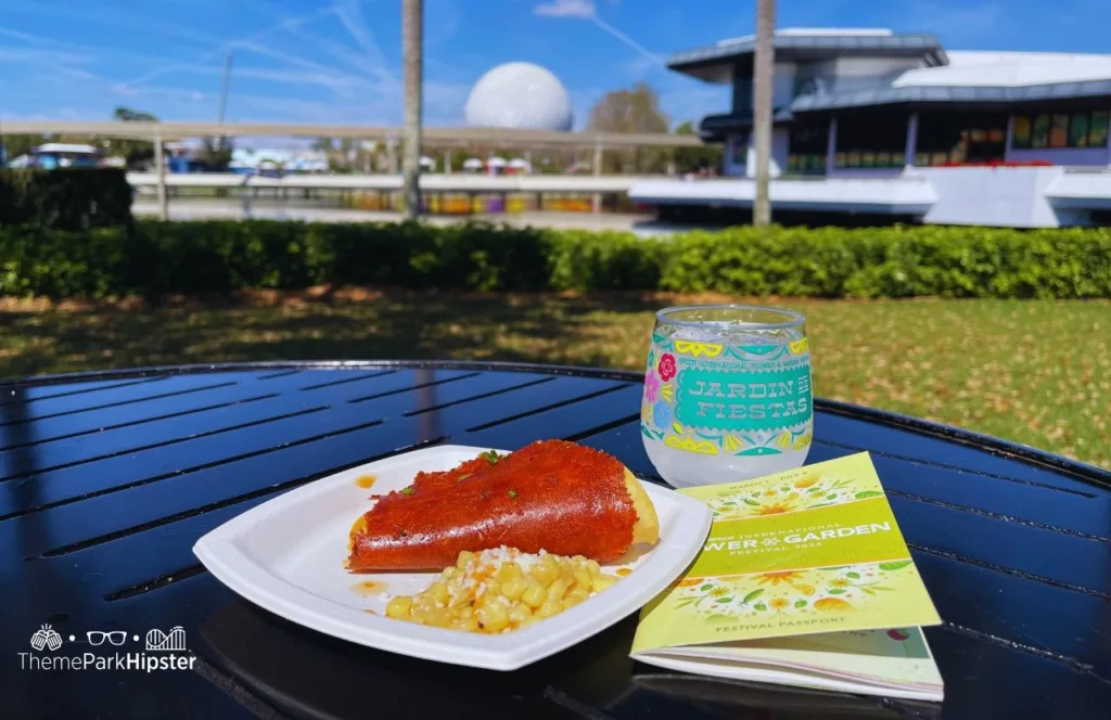 Epcot Flower and Garden Festival 2023 Mexican Food Booth with Spaceship Earth in the Background and Margarita. Keep reading to know what to pack and what to wear to Disney World in June for your packing list.