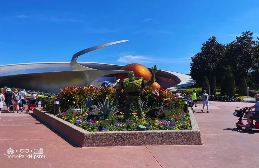 Epcot Flower and Garden Festival Mission Space with Buzz Lightyear Topiary. Keep reading to get the world rides at Epcot for solo travelers on a solo disney world trip.