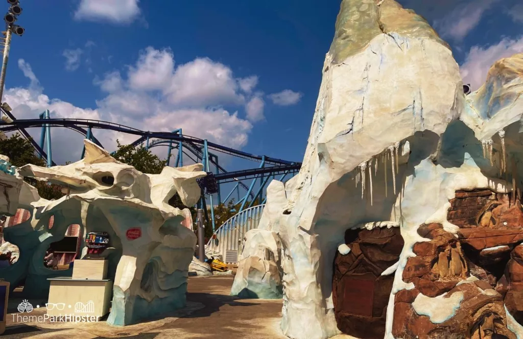 SeaWorld Orlando Resort Empire of the Penguin Exhibit Antartica with Manta Roller Coaster in background next to Expedition Cafe. Keep reading to learn more about the best SeaWorld Orlando restaurants.