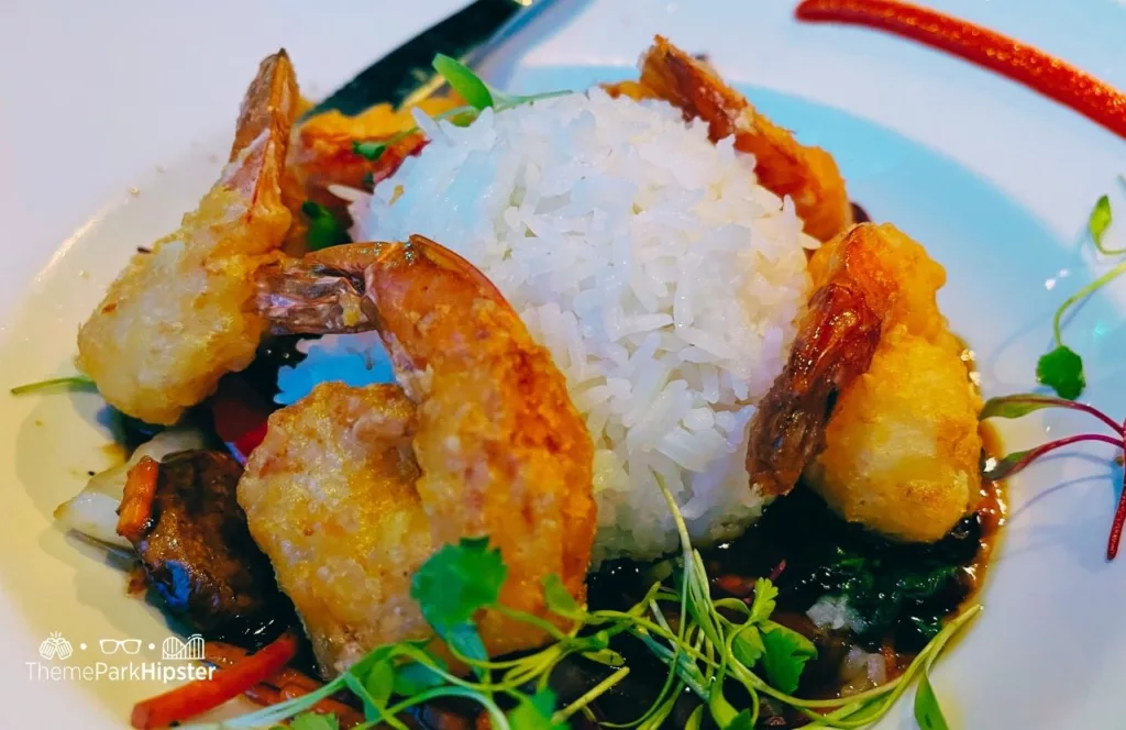 SeaWorld Orlando Resort Sharks Underwater Grill Fried Shrimp with Rice on teriyaki bed. Keep reading to learn more about the best SeaWorld Orlando restaurants.