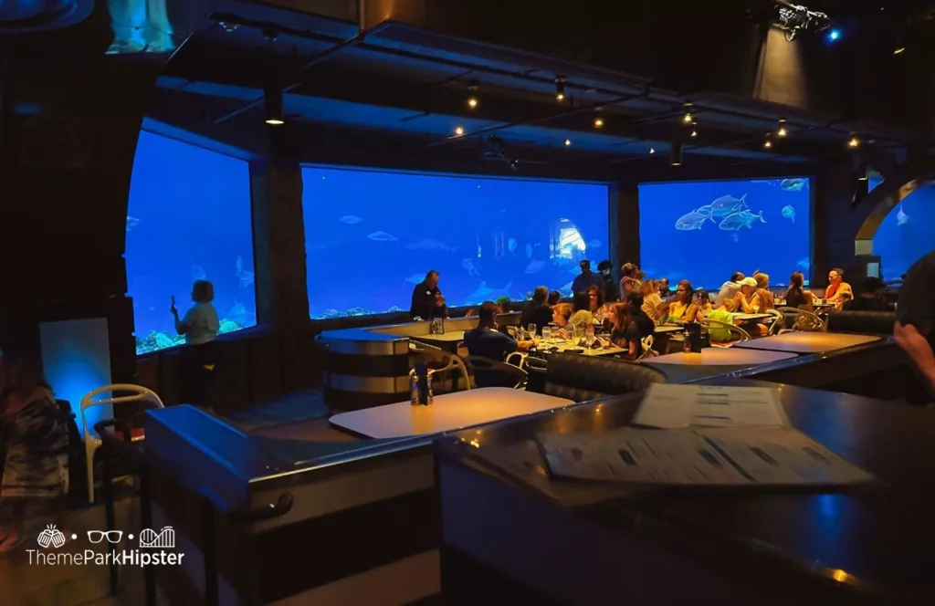 SeaWorld Orlando Resort Sharks Underwater Grill interior. Keep reading to get the full SeaWorld Orlando parking travel guide.