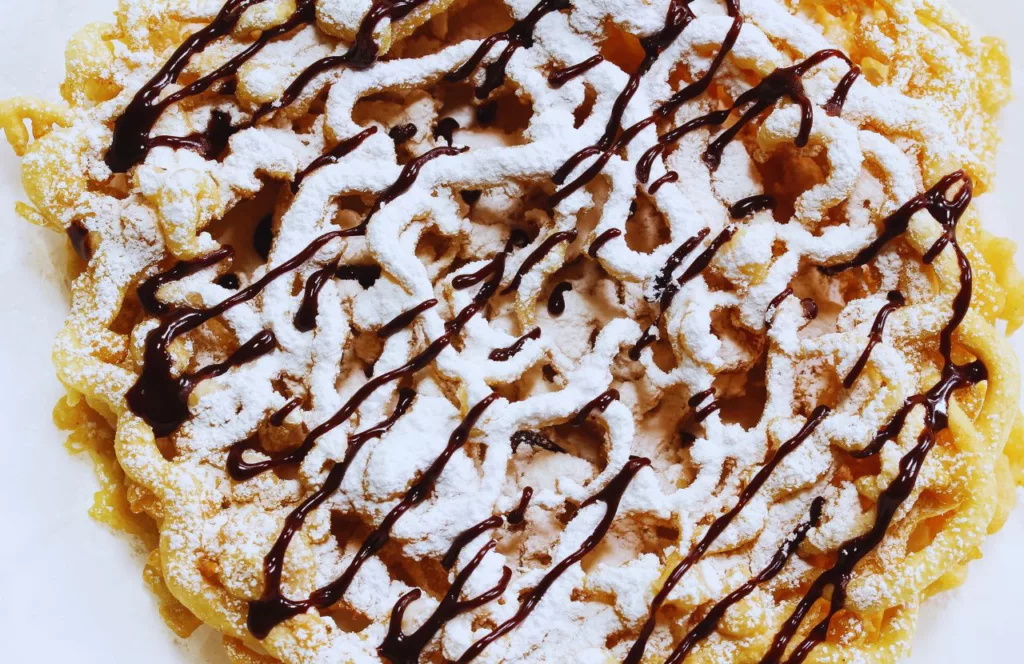 Funnel Cake topped with powered sugar and chocolate. Some of the best food at Hersheypark.