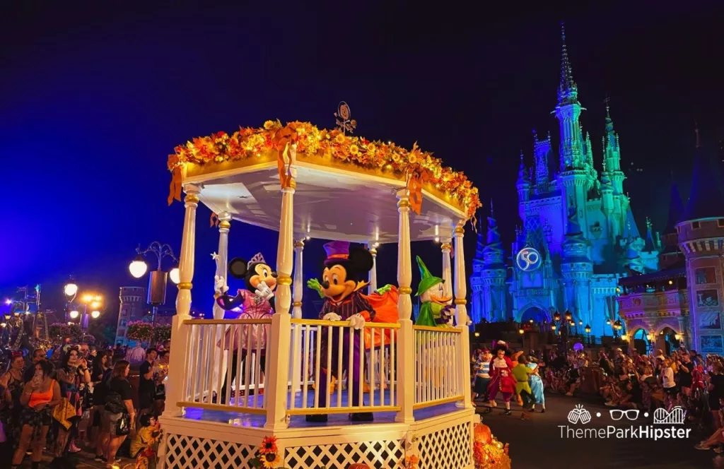 Mickey's Not So Scary Halloween Party at Disney's Magic Kingdom Theme Park Boo to You Halloween Parade in front of Cinderella Castle with characters Mickey and Minnie Mouse and Daisy Duck. Keep reading to get the best hip packs and fanny packs for Disney World.