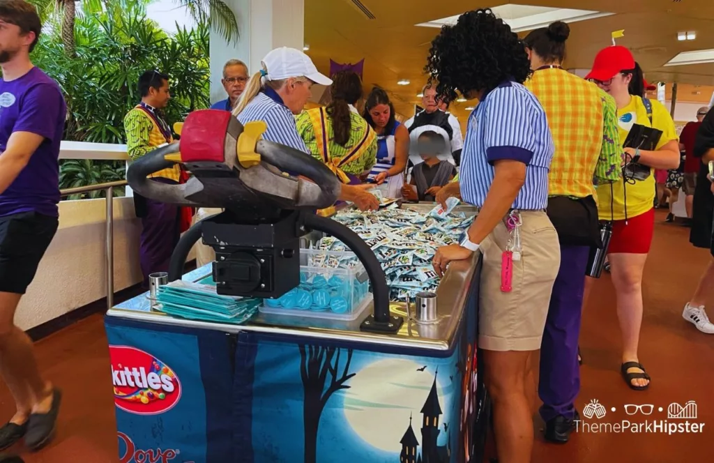 2023 Mickey's Not So Scary Halloween Party at Disney's Magic Kingdom Theme Park Cast Member Passing out M&M candy trick or treat trail.