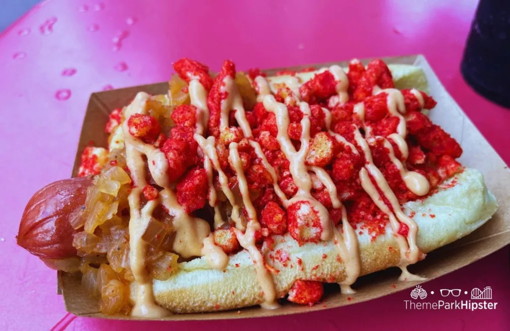 Mickey's Not So Scary Halloween Party at Disney's Magic Kingdom Theme Park Hotdog Topped with onions firehot cheetos and sauce at Casey's Corner. One of the best restaurants at Magic Kingdom.