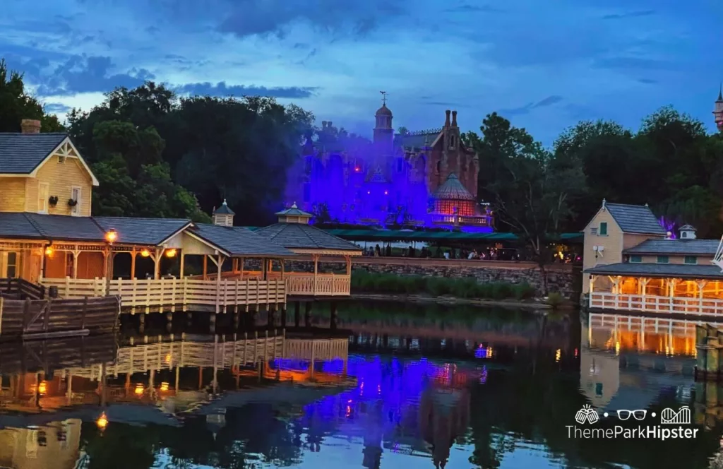 Mickey's Not So Scary Halloween Party at Disney's Magic Kingdom Theme Park Tom Sawyer Island and Haunted Mansion at Night over the lagoon