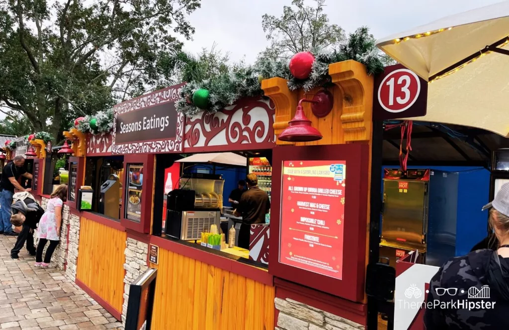 SeaWorld Orlando Christmas Celebration Seasons Eatings Food Booth. Keep reading to learn more about SeaWorld Orlando Christmas Celebration food.