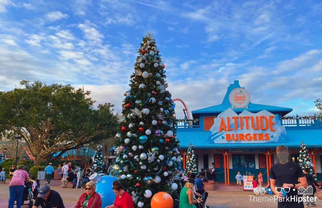 SeaWorld Orlando Resort Christmas Celebration Holiday tree in front of Altitude Burgers. Keep reading to find out more about SeaWorld Orlando Christmas Celebration food.