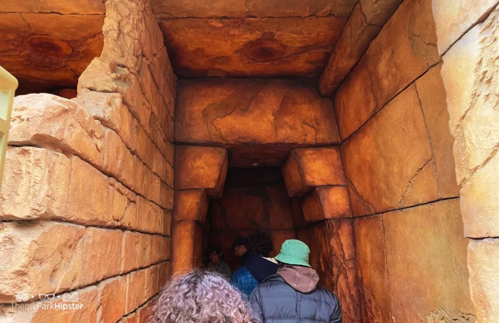 Universal Studios Hollywood Revenge of the Mummy Ride with guests entering a replica of an ancient corridor. Keep reading to learn more about the best Universal Studios Hollywood attractions.