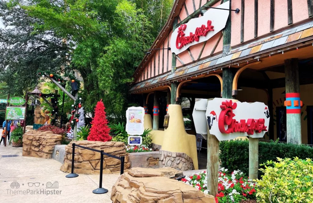 Busch Gardens Tampa Bay Chick Fil A Food Restaurant with stone planters and trees out front. Keep reading to learn more about Busch Gardens Tampa restaurants.