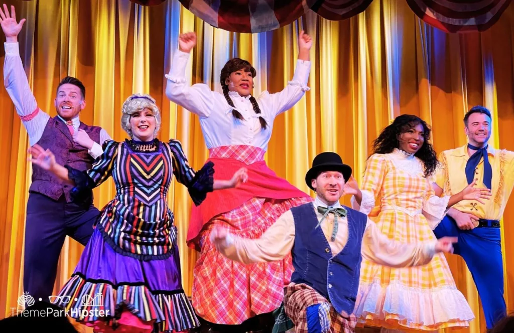 Cast performing on stage at Disney Wilderness Lodge Resort Hoop Dee Doo Musical Revue. Keep reading to discover more of the best things to do at Disney World for solo travelers.