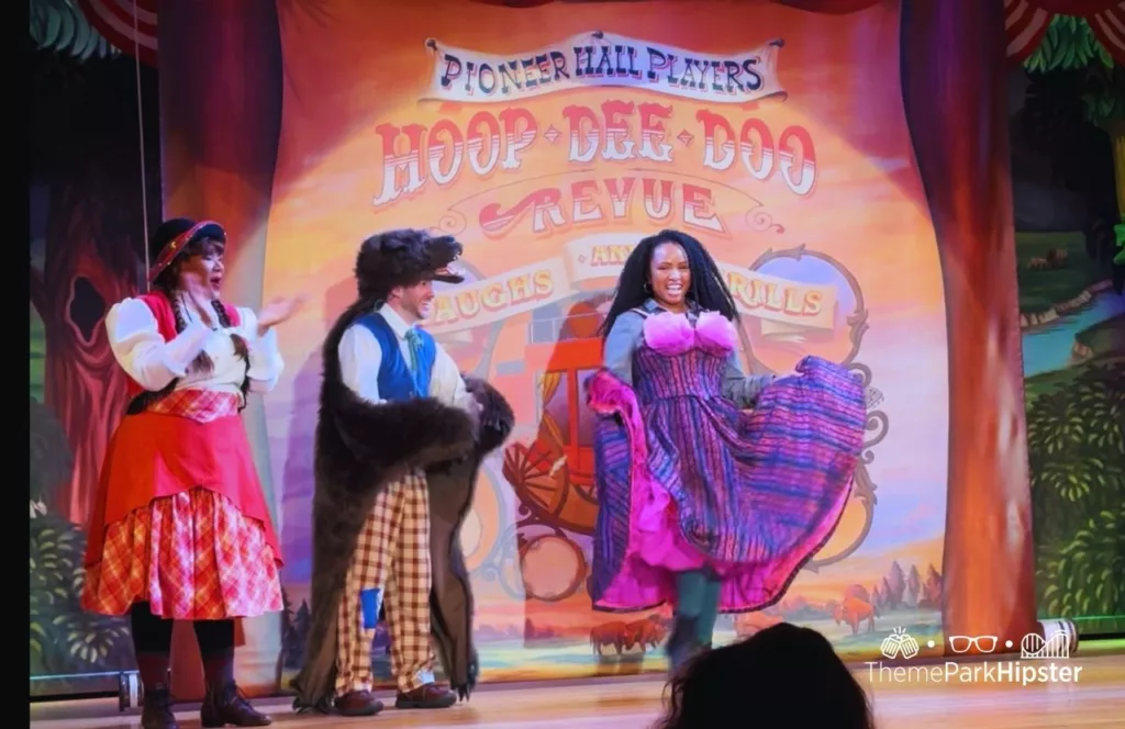 NikkyJ joining the cast on stage at the Hoop Dee Doo Musical Revue Disney Wilderness Lodge Resort. Keep reading to discover more of the best things to do at Disney World on a solo trip. 
