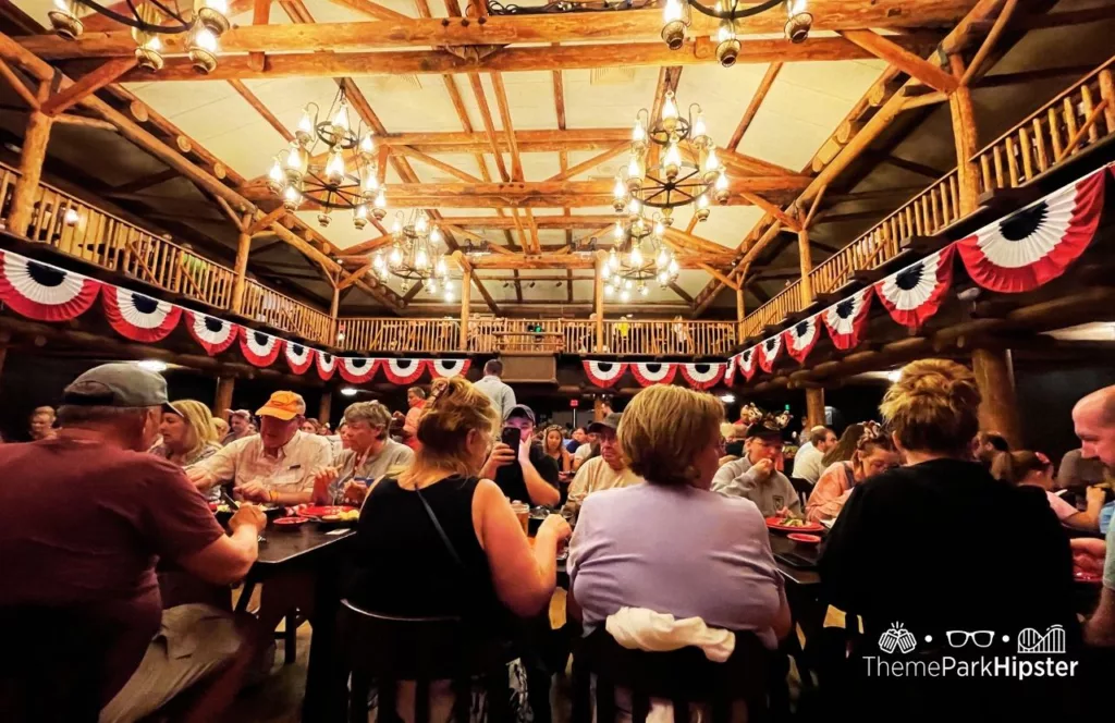 Disney Wilderness Lodge Resort guest sitting down at Hoop Dee Doo Musical Revue at pioneer hall