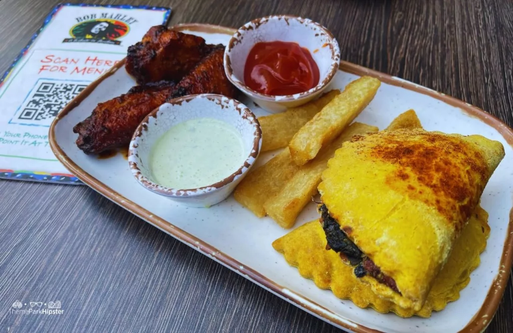 Universal Orlando Resort Bob Marley a Tribute to Freedom Restaurant in CityWalk Taste of Jamaica Jerk Wings Yuca Fries and Beef Patty. Keep reading to get the best things to do at Universal Orlando for adults.