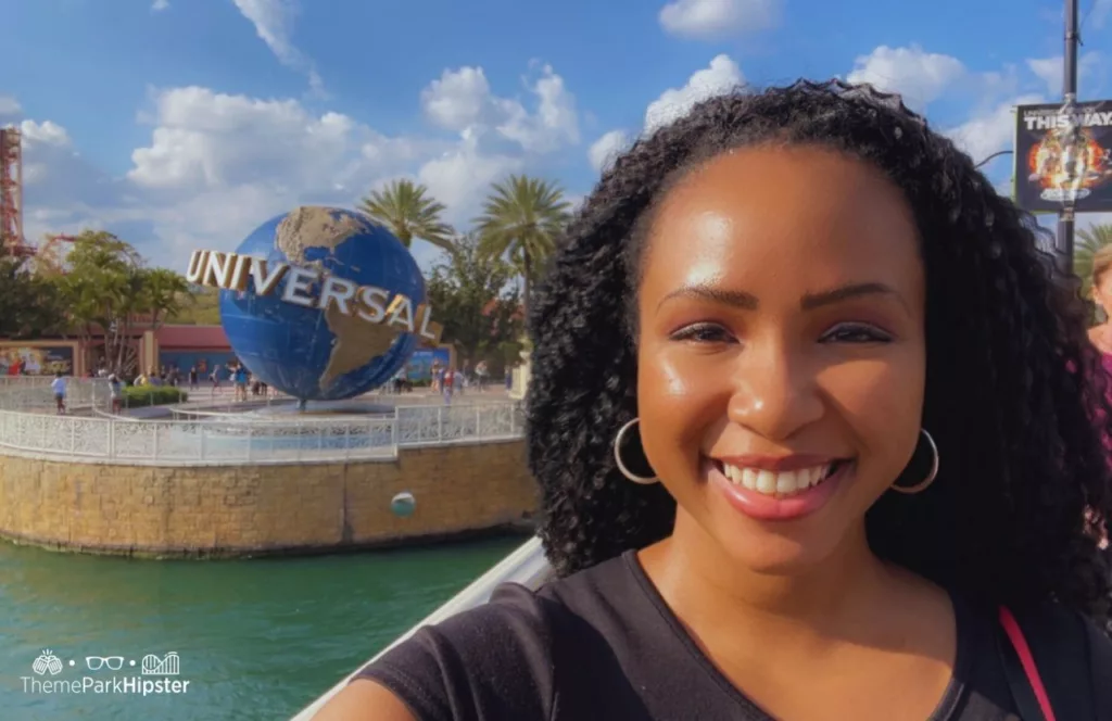 Universal Orlando Resort Globe in front of Universal Studios Arches and Hollywood Rip Ride Rockit with NikkyJ. Keep reading to learn how to have the best Universal Orlando Solo Trip for Travelers going to theme parks alone.