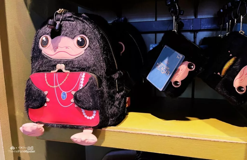 Universal Orlando Resort The Wizarding World of Harry Potter Diagon Alley Merchandise at Universal Studios Florida Niffler Loungefly Bag and Wallet. One of the best Harry Potter gifts for adults who are fans!