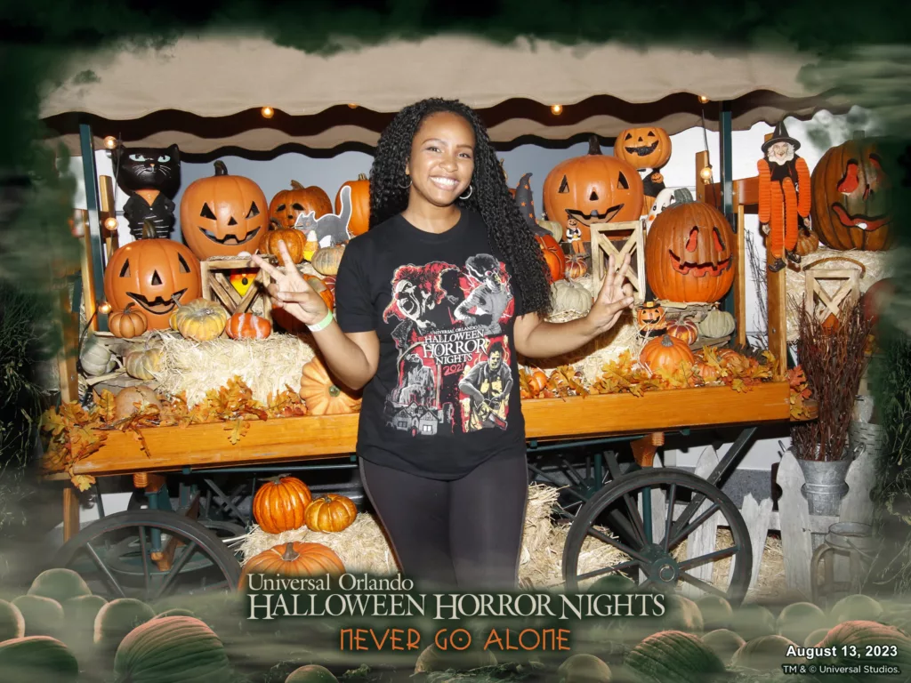 NikkyJ at Halloween Horror Nights 2023 Taste of Terror Food Event in a black Halloween Horror Nights t-shirt and black comfortable leggings. Keep reading to see what to wear to Halloween Horror Nights.