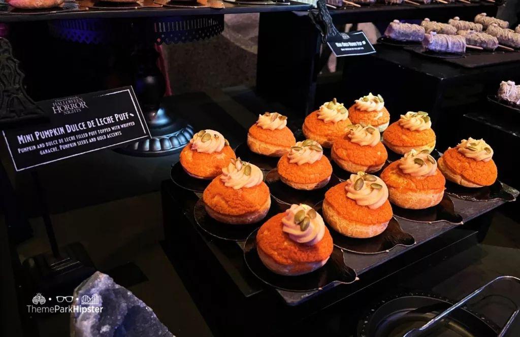 Universal Orlando Resort Halloween Horror Nights a Taste of Terror HHN Food Hellfire Club Dessert Mini Pumpkin Dulce De Leche Puff. Keep reading to learn about the best Universal Studios Halloween Horror Nights food and drink that you must try!