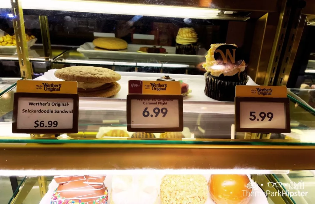 2023 Epcot Festival of the Holidays at Disney Germany Pavilion Karamell Kuche Wether's Sweet Shop Snickerdoodle Gingerbread Sandwich Caramel Flight and Cupcake. One of the best Disney World Christmas snacks and treats to eat!