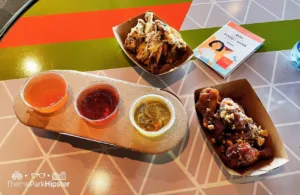 2023 Epcot Food and Wine Festival at Disney Odyssey Cider Flight with Parmesan and Peanut Butter and Jelly Chicken Wings