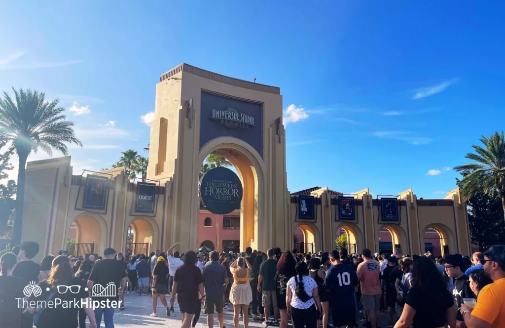 2023 Halloween Horror Nights HHN 32 Universal Studios Orlando sign with a large crowd of theme park guests. Keep reading to find out more about Halloween Horror Nights Stay and Scream.