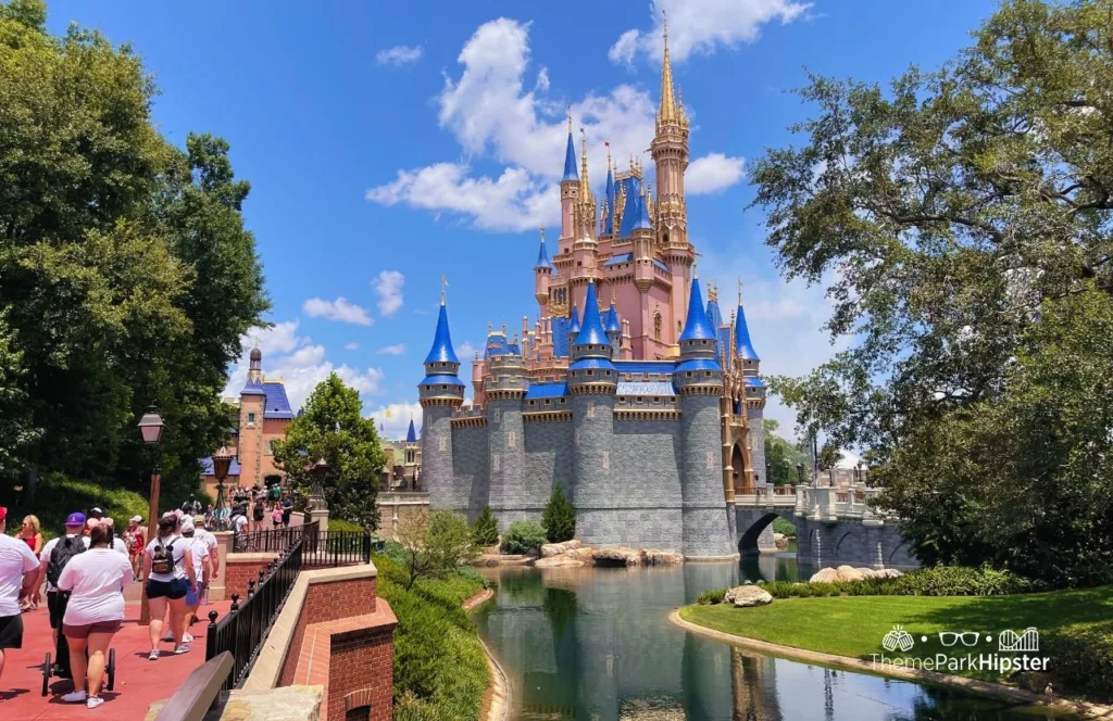 Disney Liberty Square View of Cinderella Castle at Magic Kingdom Theme Park on a crowded day. Keep reading to know which is better Disney World vs Universal Studios.