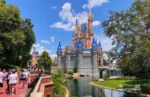 Disney Liberty Square View of Cinderella Castle at Magic Kingdom Theme Park on a crowded day. Full guide to the best time to visit Disney World and 3 Day itinerary.