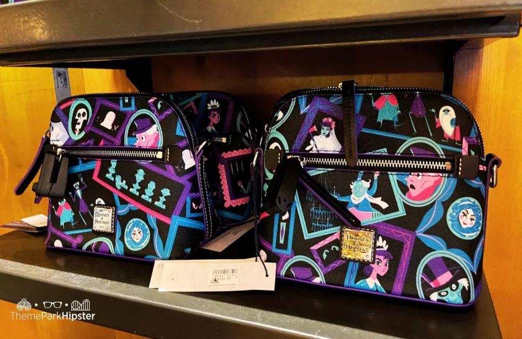 Disney Memento Mori Store Haunted Mansion Merchandise at Magic Kingdom Theme Park Dooney and Burke Purse. Keep reading for more Disney Haunted Mansion Merchandise Gift Ideas.