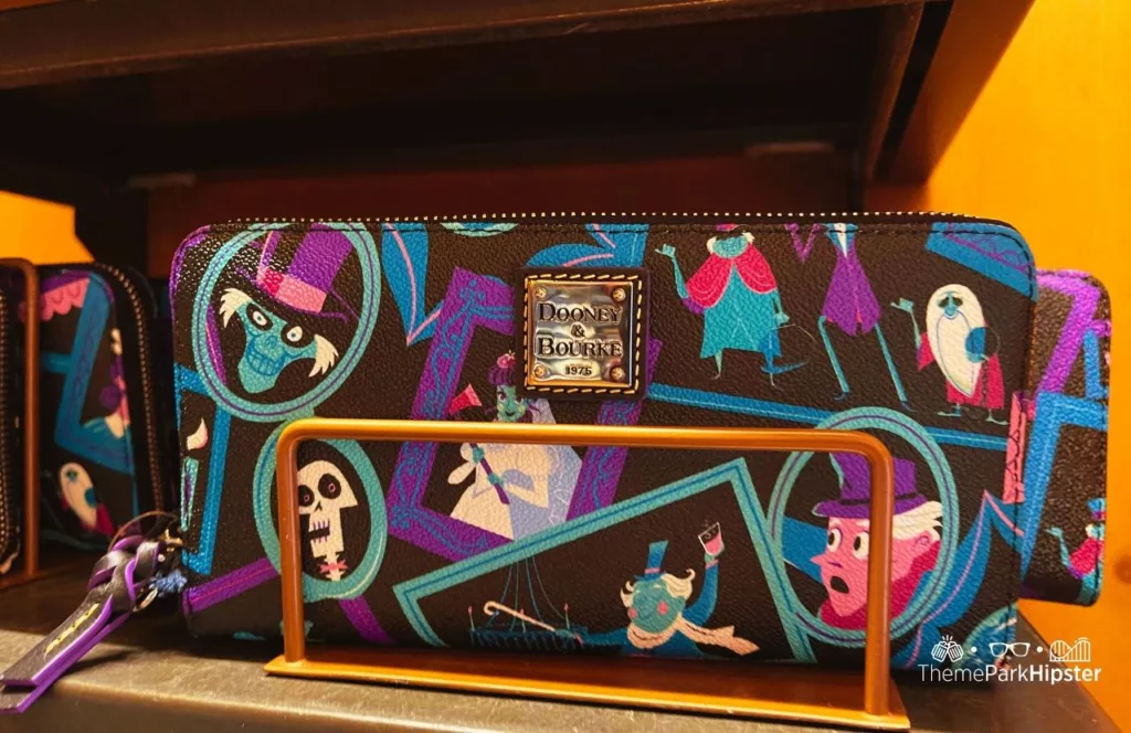 Disney Memento Mori Store Haunted Mansion Merchandise at Magic Kingdom Theme Park Dooney and Burke Wallet. Keep reading for more Disney Haunted Mansion Merchandise Gift Ideas.